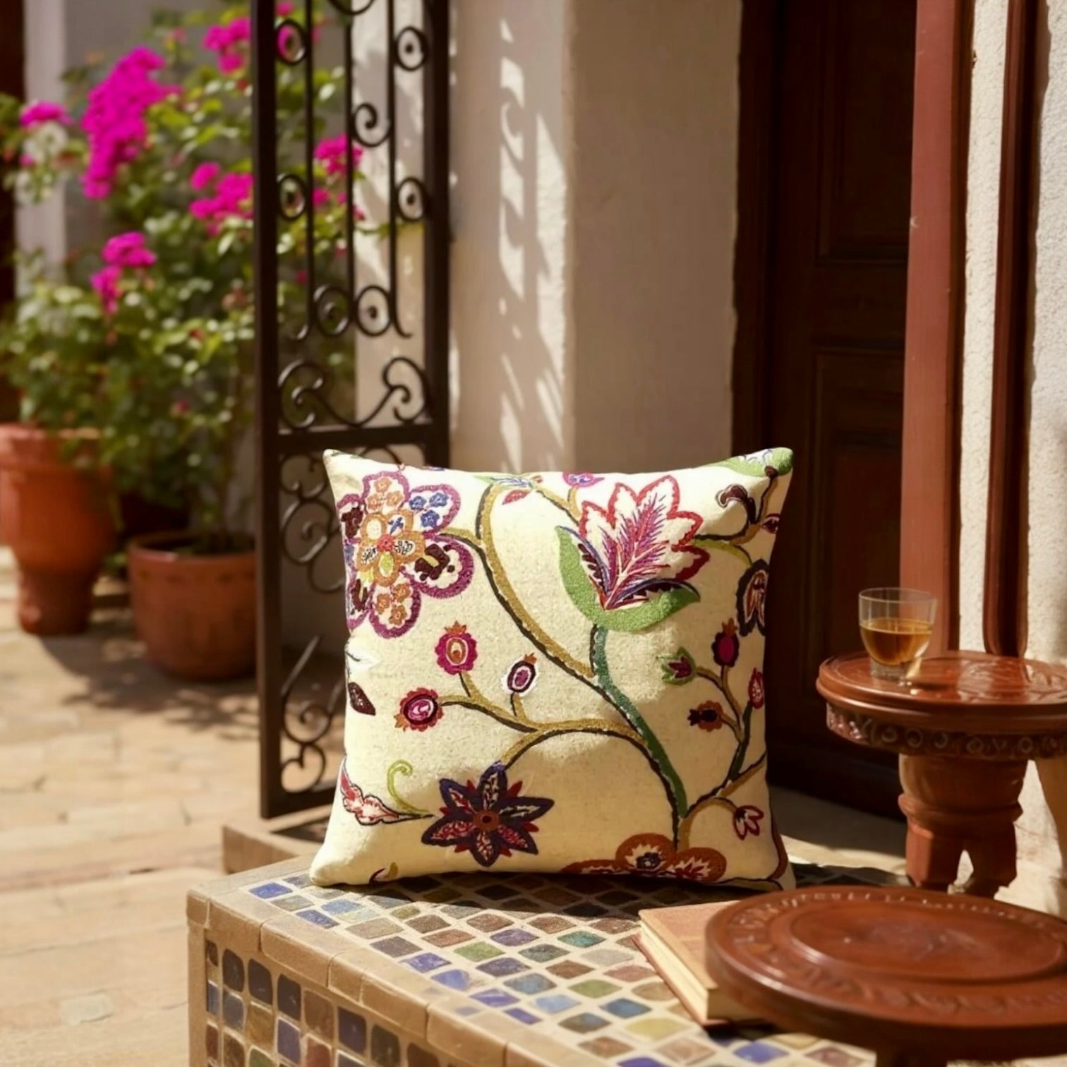 Multicoloured floral embroidery on cream wool felt cushion