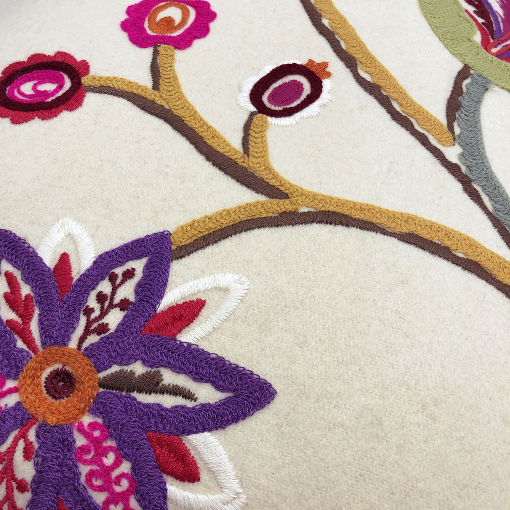 Multicoloured floral embroidery on cream wool felt cushion